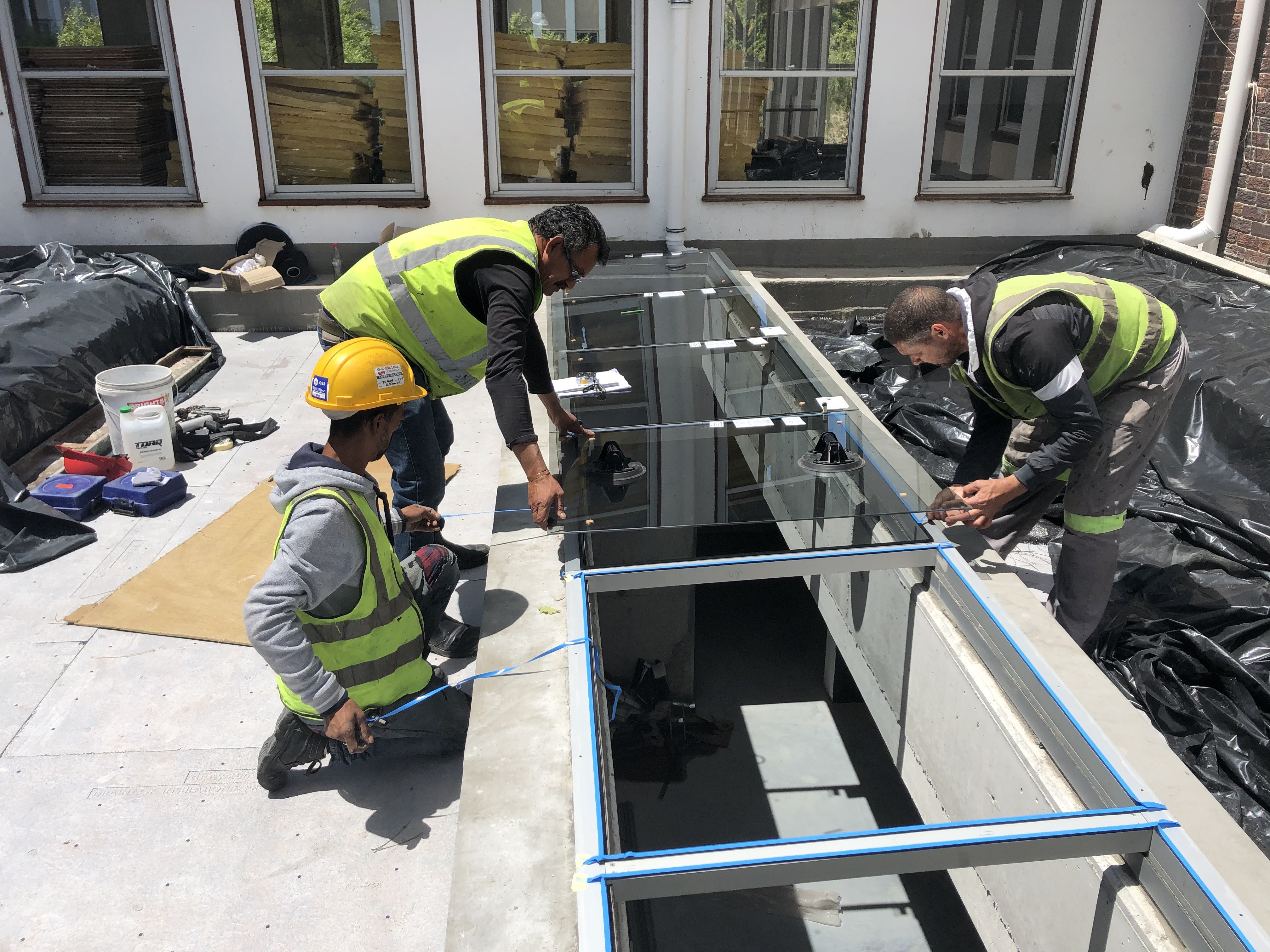 glass being installed in skylights